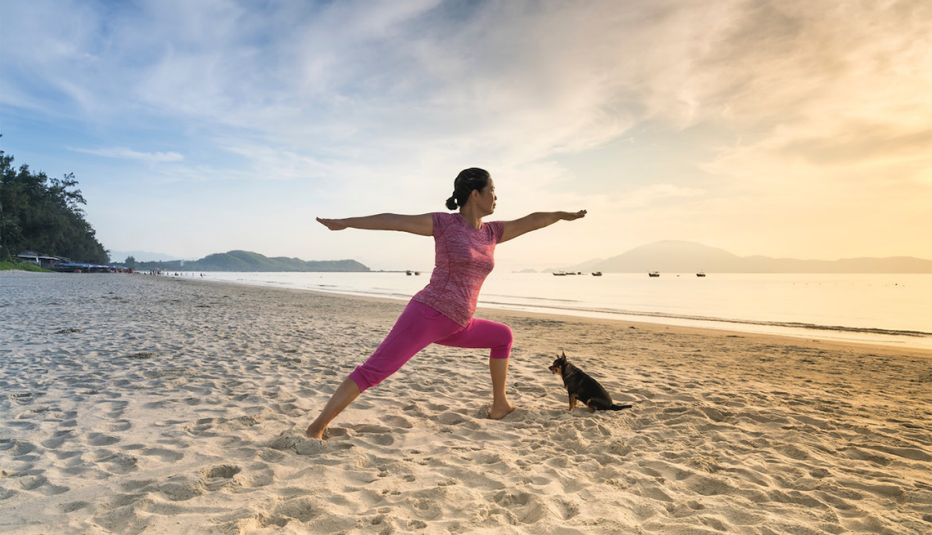 A woman doing yoga on the beach