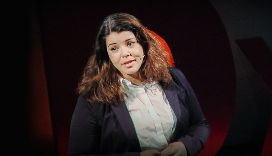 A woman, Celeste Headlee. speaking on stage at a TED event