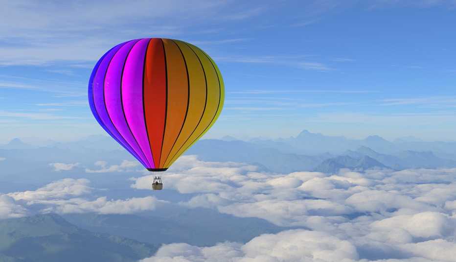 A hot air balloon flying over mountains