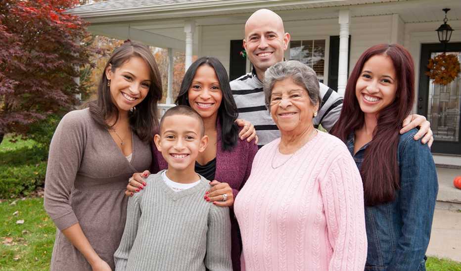 A family photo taken outside the front of a home