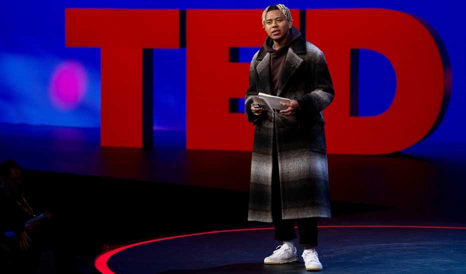 A man, Cordae, speaking on stage at SESSION 5 at TED2022 A man, Cordae, speaking on stage at SESSION 5 at TED2022