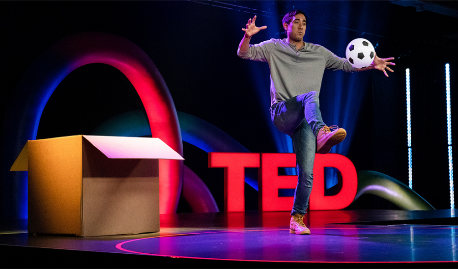 A man, Zach King, speaking on stage at TEDMonterey