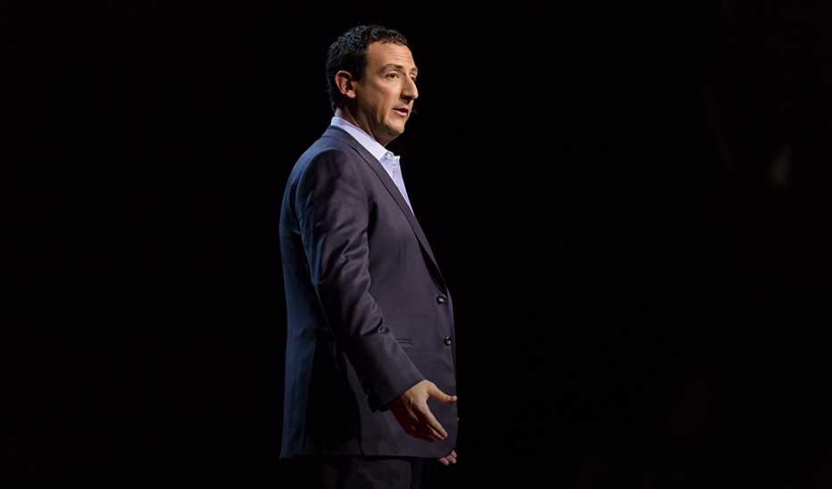 A man, Isaac Lidsky, speaking on stage at TEDSummit2016