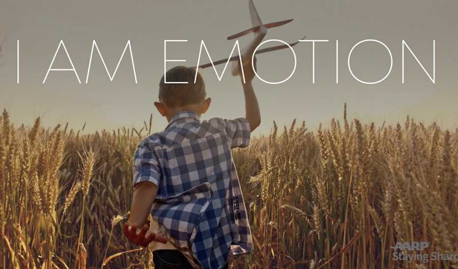 A boy playing with a toy plane in a field with "I Am Emotion" text
